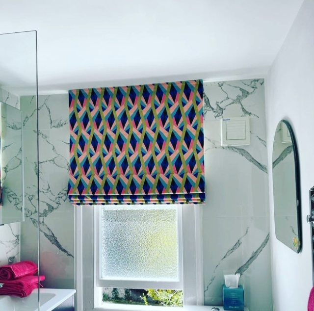Patterned Roman blind fitted to a bathroom sash window in London